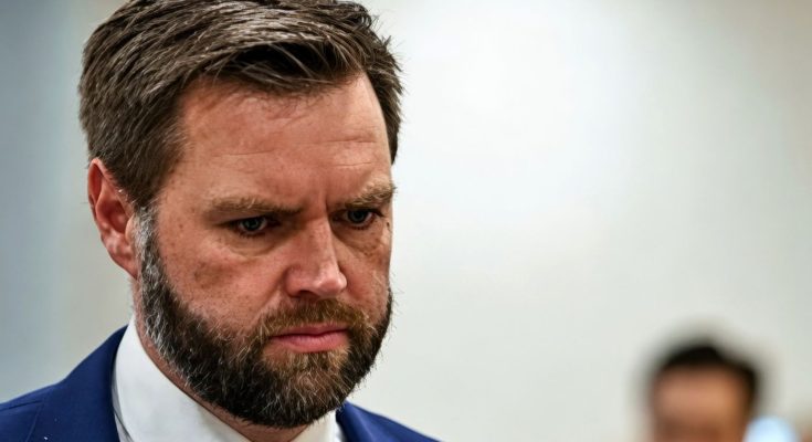serious man in suit looking down in a focused setting